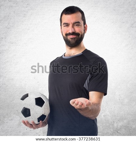Football player holding something over textured background