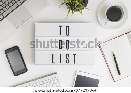 To do list words on office table with computer, coffee, notepad, smartphone and digital tablet