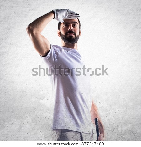 Golfer man showing something over textured background