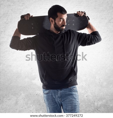 Skater man looking lateral over textured background