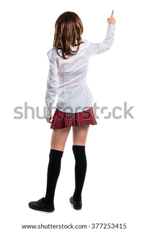 Pretty young girl pointing back