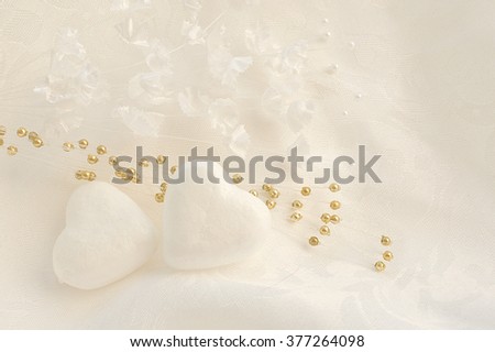 White wedding background with hearts on fabric.