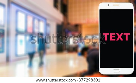 Blur image in the mall , have mobile phone on front use for enter the relevant text.