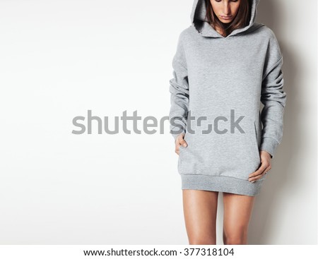 Young girl wearing blank and oversize long hoody. White background