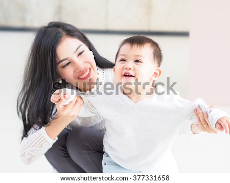 Beautiful Asian mother and son on indoor daylight.