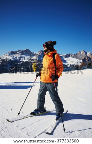 skier standing on the ski slope and looking somewhere
