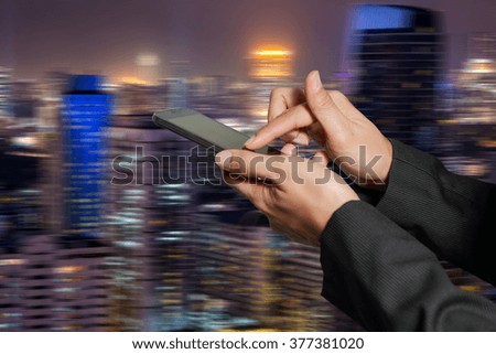 Woman hand hold and touch screen smart phone, cellphone  on motion abstract night city background as high speed of communication concept.