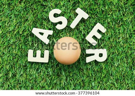 Easter blur background. grass Letters wooden word Easter egg