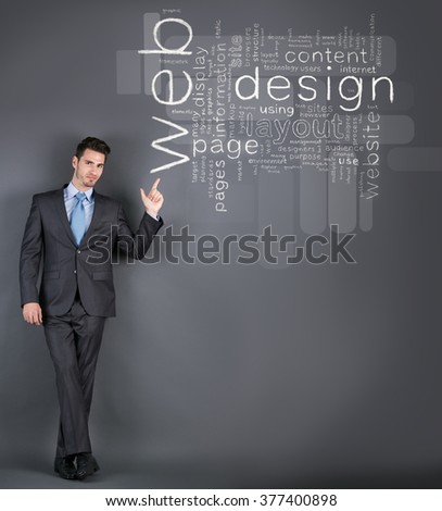 Businessman standing by a  wall with web design terms and pointing on it