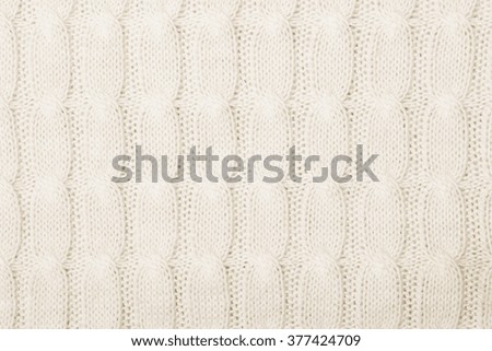 White knitted texture with ornament braids
