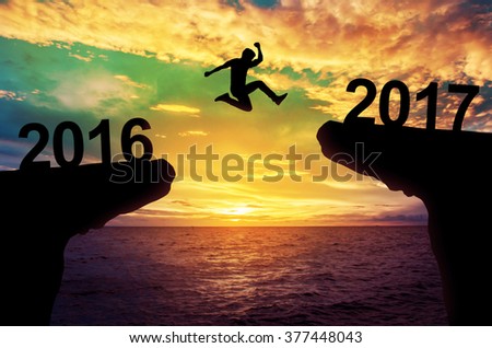 A man jump between 2015 and 2016 years. Royalty-Free Stock Photo #377448043