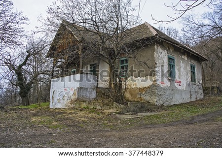Old abandoned chalet in the woods.