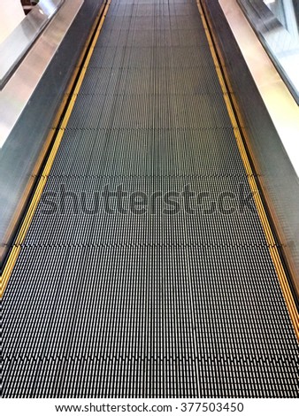 going up with escalator at shopping mall