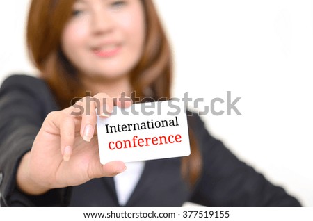 International  conference message on the card shown by a businesswoman, 