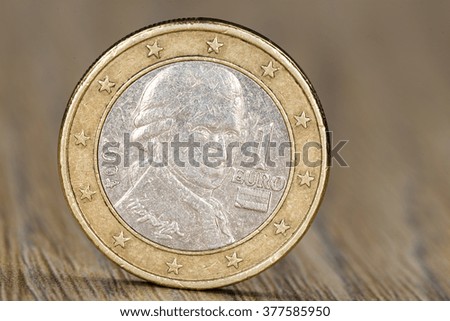Close up of a one euro coin from the European Union member Austria showing the portrait of Wolfgang Amadeus Mozart, a famous composer