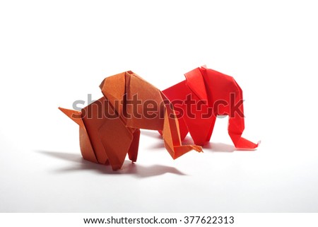 Red and orange origami elephants isolated on white background