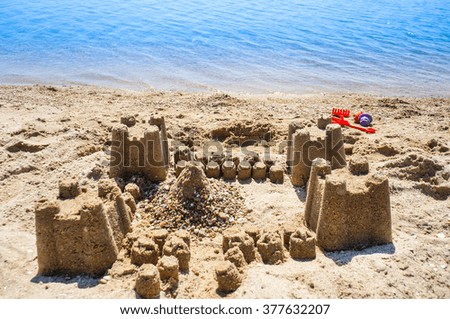Sand castle on beach with sea on the background. daylight