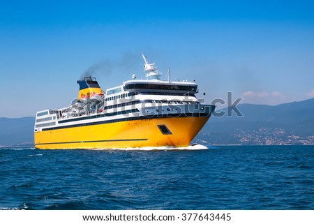 Big yellow passenger ferry goes on the Mediterranean Sea near Corsica island, France Royalty-Free Stock Photo #377643445