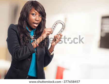 black woman holding a horseshoe