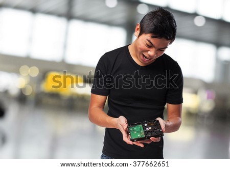 worried chinese man with a hard-drive