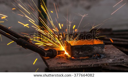 Metal cutter, steel cutting with acetylene torch, industrial worker on working area