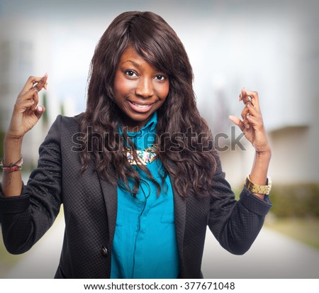 happy black-woman crossing fingers
