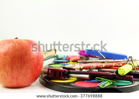 books apple and school supply on white background