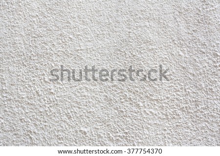 Stucco wall - White stucco textured wall background with natural light. Royalty-Free Stock Photo #377754370