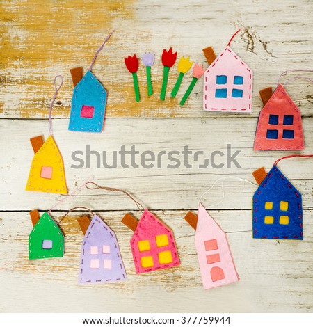 Handmade little houses over wooden background