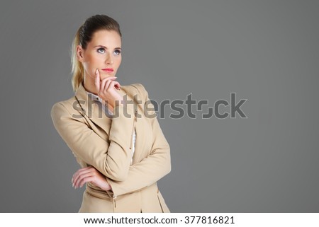 Picture of businesswoman thinking over grey background