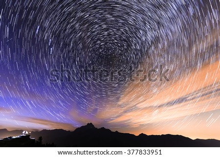 star trail at  cloudy night in summer in mountains