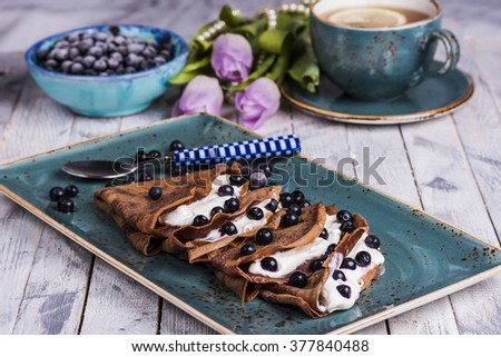 chocolate crepes with cream cheese and blueberries for Breakfast Royalty-Free Stock Photo #377840488