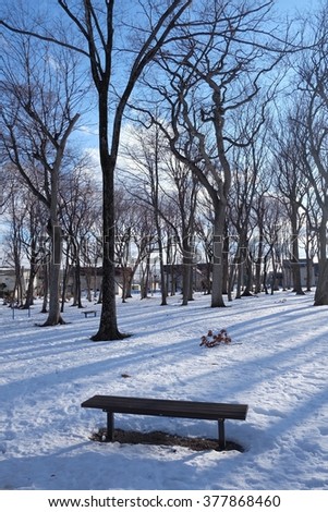 A bench in the park that full of snow