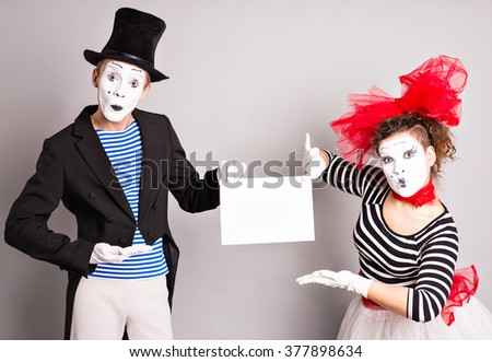 Two mimes   with a sign for advertising, April Fools Day concept