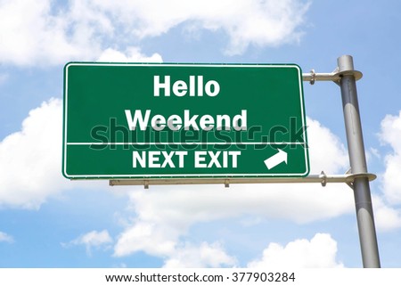 Green overhead road sign with a Hello Weekend Next Exit concept against a partly cloudy sky background. Royalty-Free Stock Photo #377903284