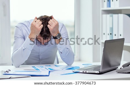 business, people, paperwork and deadline concept - stressed businessman with papers and charts sitting at table in office Royalty-Free Stock Photo #377904673
