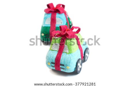 Cartoon cute blue green kraft paper Christmas tree toy car isolated on white background, wrapped ribbon bow, with place for your text. Happy birthday for boys. Happy New Year.