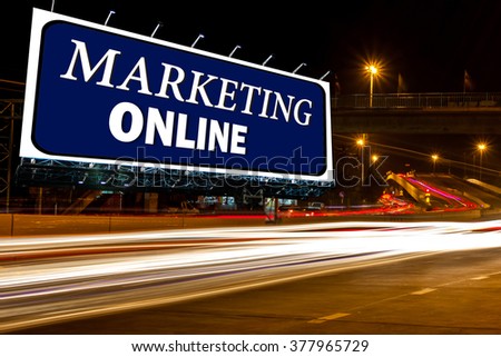 billboard with inspiration marketing online over street light at night time,abstract background for and advertisement concept.