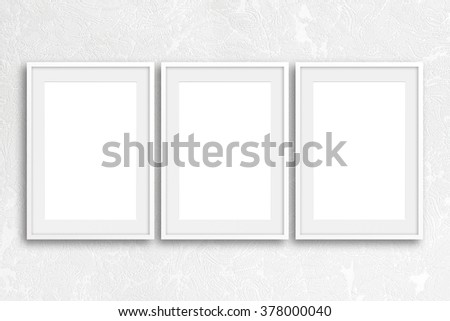Three blank frames mock up on modern textured wallpaper