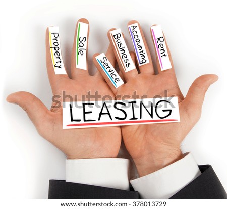 Photo of hands holding paper cards with LEASING concept words