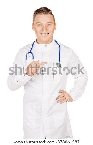 Young  male doctor in white coat and stethoscope finger point up. People and medicine concept. Image isolated on a white studio background.