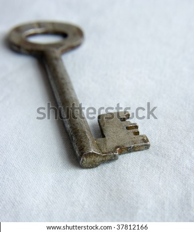 very old key on blue background