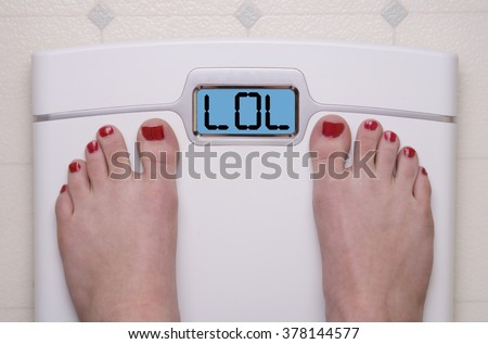 Digital Bathroom Scale Displaying LOL text Royalty-Free Stock Photo #378144577