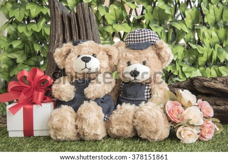 couple teddy bears with rose and present on garden background,  two teddy bear picnic in garden love concept vintage style
