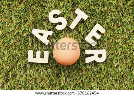 Easter blur background. grass Letters wooden word Easter egg