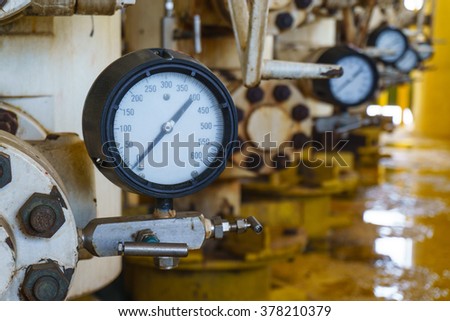 Pressure gauge for monitoring measure pressure in oil and gas process, Offshore oil and gas industry.Oil and gas wellhead platform in the gulf or the sea, The world energy. Royalty-Free Stock Photo #378210379