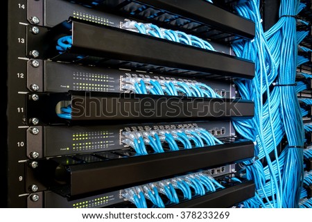 Many network switch hubs and ethernet cable in rack cabinet. Network connection technology and has a status LED to show working status Royalty-Free Stock Photo #378233269