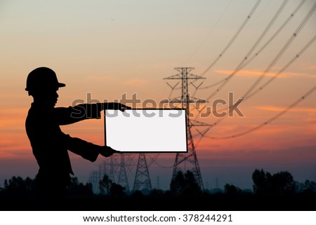 silhouette black man survey and civil engineer  casual man holding white sign to write it on your text over Blurred construction worker on construction site. examination, inspection, survey