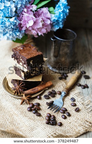 Home made brownies on vintage plate with vintage silverware and hydrangea flowers