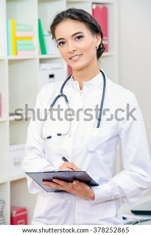 Smiling female doctor in white coat looking at camera. Medicine, healthcare. 